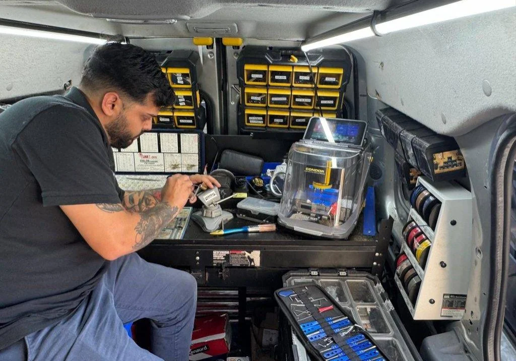 Super Hero Locksmith technician working at a mobile key programming station